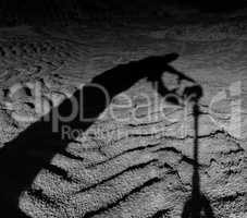 Square black and white scary man shadow taking photo camera on t