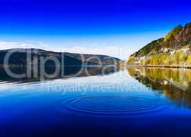 Horizontal vivid Norway day river water circles drops background