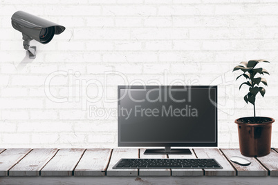 Composite image of a computer over a desk