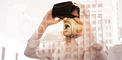 Composite image of businessman holding virtual glasses