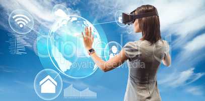 Composite image of rear view of businesswoman holding virtual gl