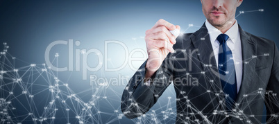 Composite image of serious businessman writing with marker