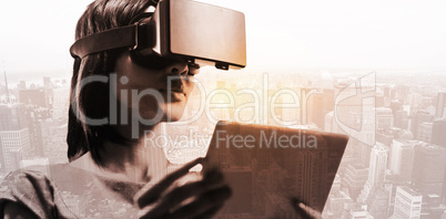 Composite image of businesswoman holding virtual glasses and tab