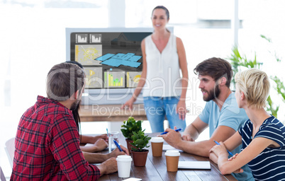 Composite image of casual businesswoman giving presentation to h