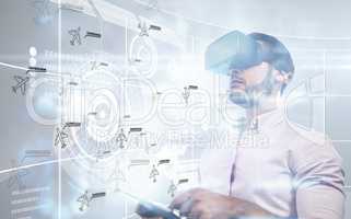 Composite image of man using an oculus and a tablet