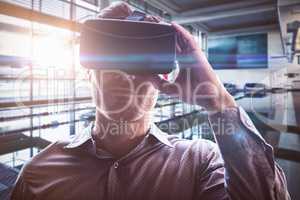 Composite image of man using an oculus