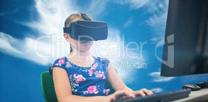 Composite image of little girl holding virtual glasses front of