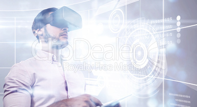 Composite image of man using an oculus and a tablet