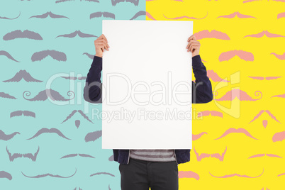 Composite image of man showing billboard in front of face