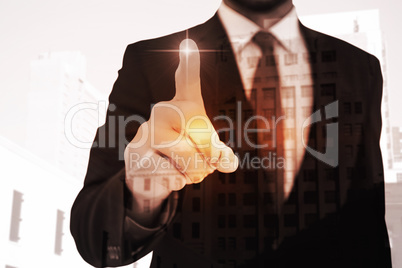 Composite image of businessman pointing his finger at camera