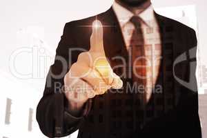 Composite image of businessman pointing his finger at camera