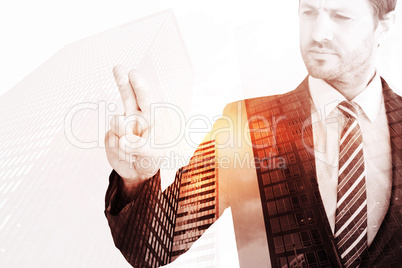 Composite image of businessman pointing with his finger