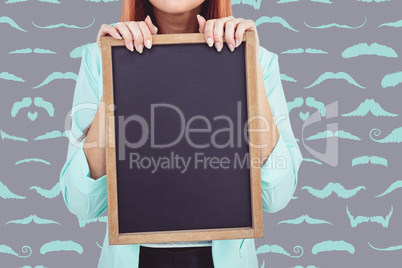 Composite image of smiling hipster woman holding blackboard Composite image of smiling hipster woman holding blackboard