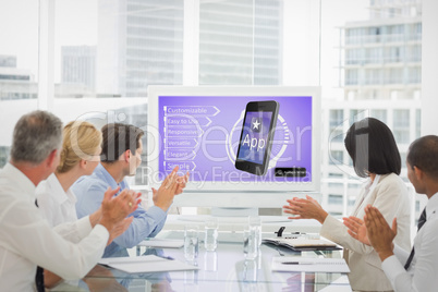 Composite image of business team clapping during a conference