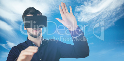 Composite image of businessman holding virtual glasses on a whit