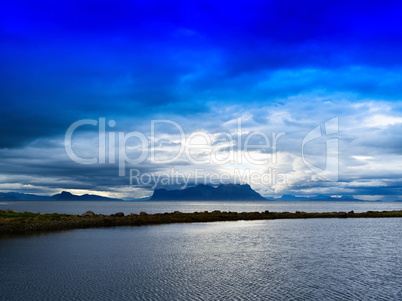 Horizontal vivid Norway fjord ocean bay with dramatic clouds bac