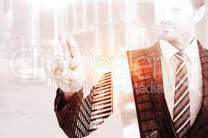 Composite image of businessman pointing with his finger