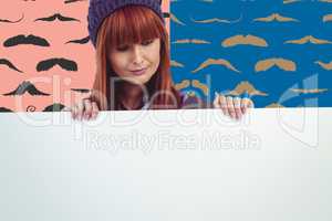 Composite image of smiling hipster woman holding big white card