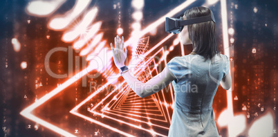 Composite image of rear view of businesswoman holding virtual gl