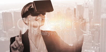 Composite image of businesswoman holding virtual glasses on a wh