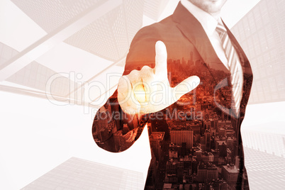 Composite image of businessman pointing with his finger