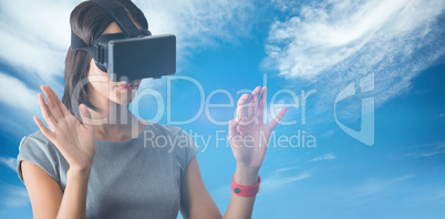 Composite image of businesswoman holding virtual glasses on a wh