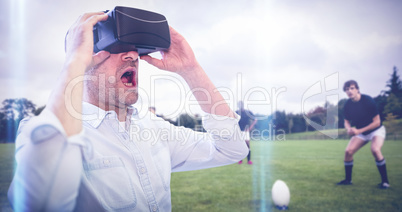 Composite image of businessman holding virtual glasses