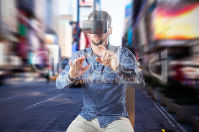 Composite image of man using virtual reality headset