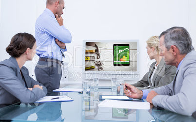 Composite image of business team looking at white screen
