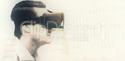 Composite image of profile view of businessman holding virtual g
