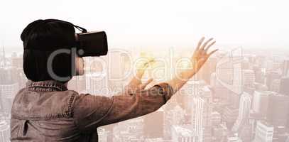 Composite image of side view of businesswoman holding virtual gl