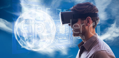 Composite image of profile view of businessman holding virtual g