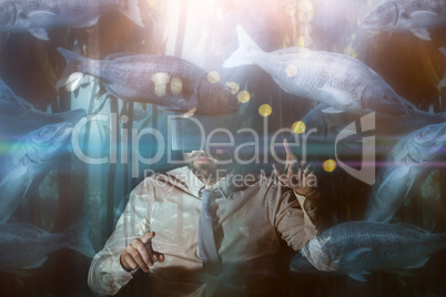 Composite image of big fish swimming in a tank