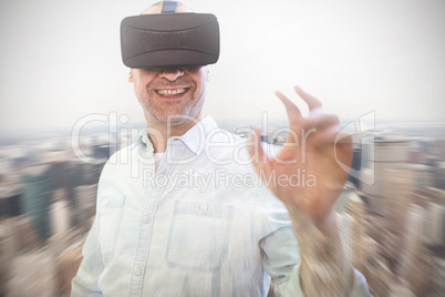 Composite image of man using an oculus