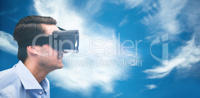 Composite image of profile view of businessman holding virtual g