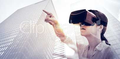 Composite image of woman using a virtual reality device