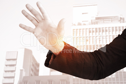 Composite image of businessman holding hand out in presentation