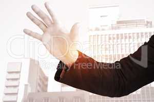 Composite image of businessman holding hand out in presentation