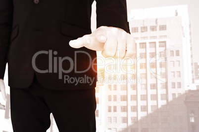 Composite image of businessman pointing with finger