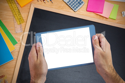 Composite image of chalkboard on desk