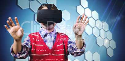 Composite image of young boy in red jumper with virtual reality