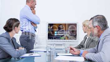 Composite image of business team looking at white screen