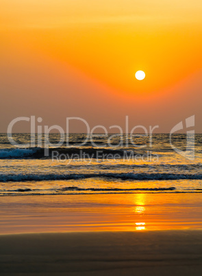 Vertical vivid orange golden sunset on ocean beach background ba