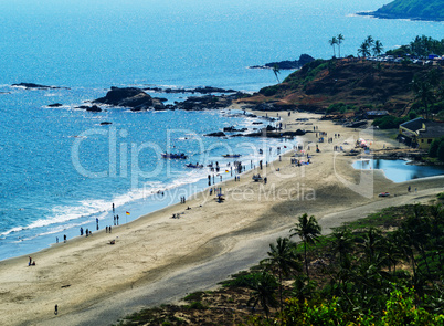 Horizontal vibrant indian beach with crowd of people background