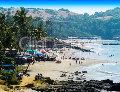 Horizontal vibrant Indian beach with crowd of people background