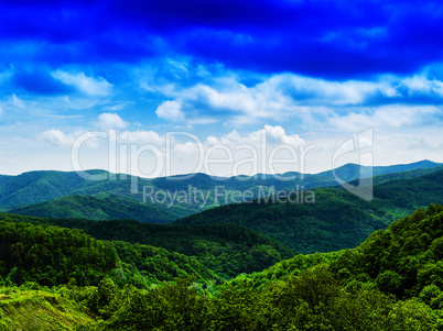 Horizontal vivid fresh hills landscape with cloudscape backgroun