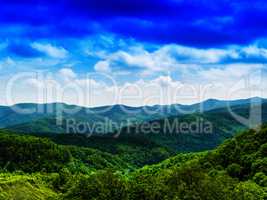 Horizontal vivid fresh hills landscape with cloudscape backgroun