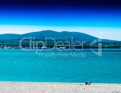 Horizontal vivid stony beach with big hill landscape background