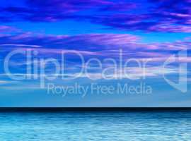 Horizontal vibrant ocean horizon with dramatic cloudscape backgr