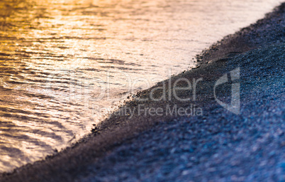 Horizontal pebble beach sunset landscape bokeh background backdr